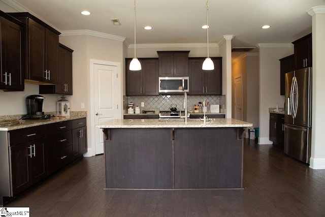 kitchen with decorative light fixtures, light stone countertops, and appliances with stainless steel finishes