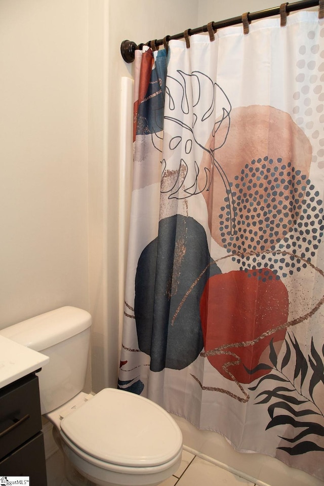 bathroom featuring tile patterned flooring, vanity, toilet, and a shower with shower curtain