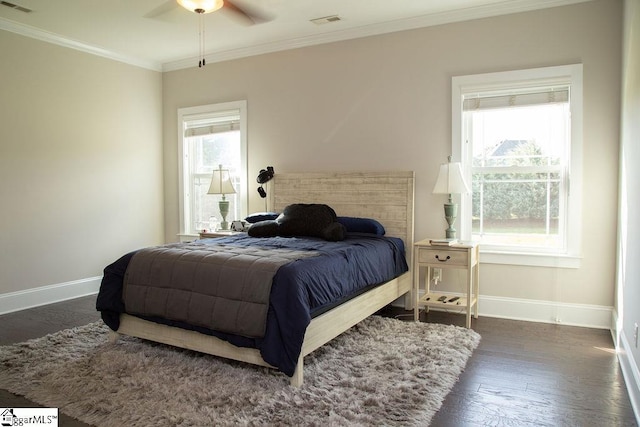 bedroom with ceiling fan, dark hardwood / wood-style floors, and ornamental molding