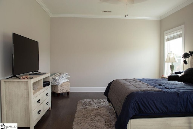 bedroom with crown molding, ceiling fan, and dark wood-type flooring