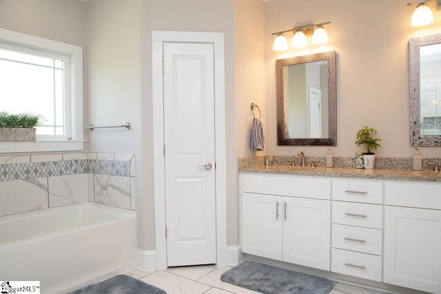 bathroom featuring a tub and vanity