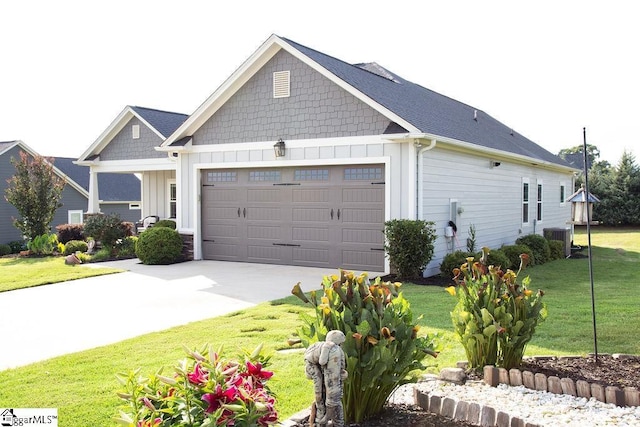 view of front of house featuring a front yard, a garage, and central AC unit