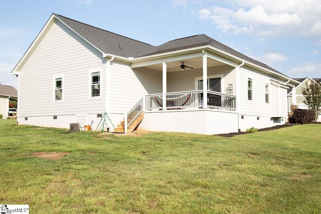 back of property featuring a lawn, central air condition unit, ceiling fan, and covered porch