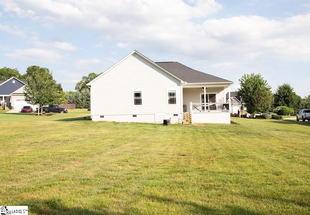 back of house featuring a porch, a yard, and ceiling fan