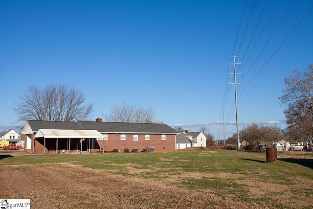 rear view of property with a yard