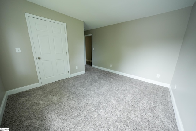 unfurnished bedroom with carpet and a closet