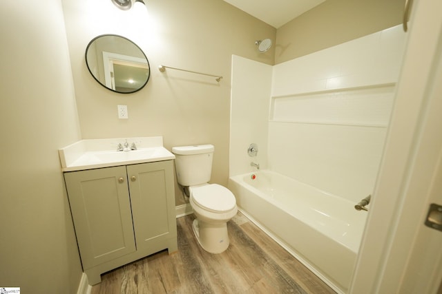 full bathroom featuring hardwood / wood-style floors, vanity, toilet, and washtub / shower combination