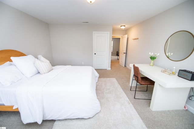 bedroom featuring light colored carpet