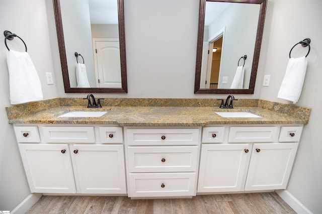 bathroom with vanity and hardwood / wood-style flooring