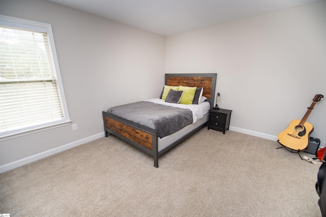 carpeted bedroom featuring multiple windows