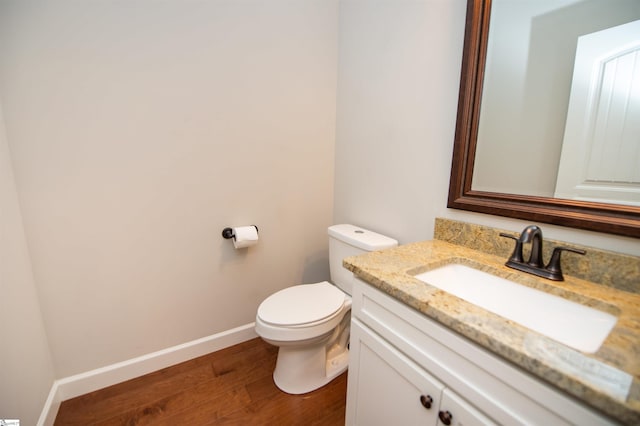 bathroom featuring hardwood / wood-style flooring, vanity, and toilet