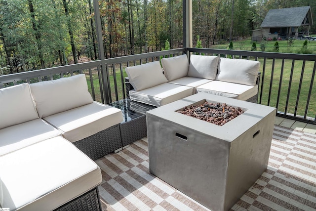 deck with an outdoor living space with a fire pit