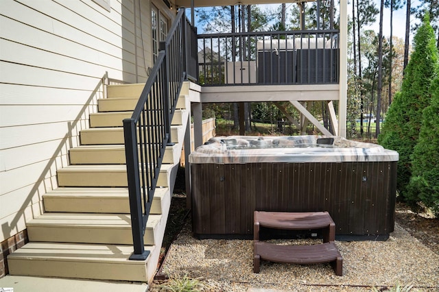 wooden deck with a hot tub