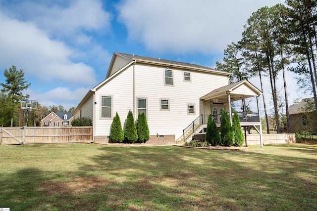 rear view of house with a yard and ceiling fan