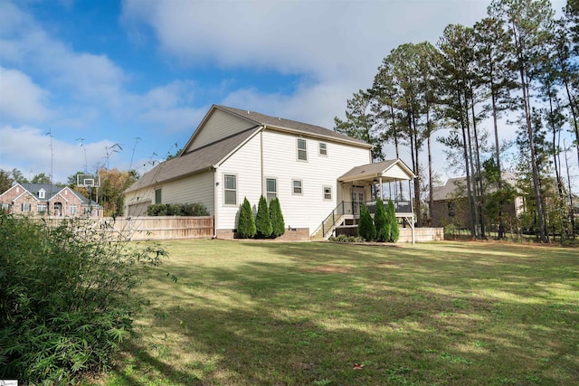 back of property featuring a yard