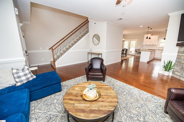 living room with wood-type flooring, french doors, ceiling fan, and ornamental molding