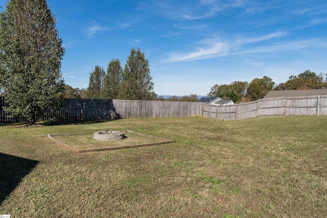 view of yard with an outdoor fire pit