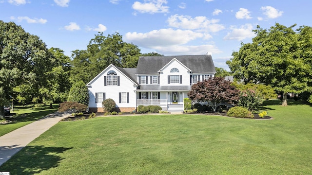 view of front of house featuring covered porch and a front lawn