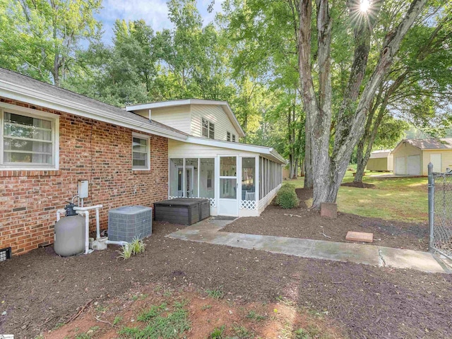 exterior space with a sunroom and cooling unit