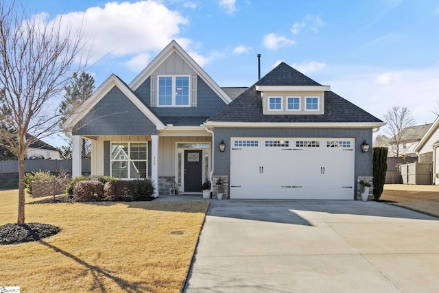 craftsman inspired home with a garage and a front lawn