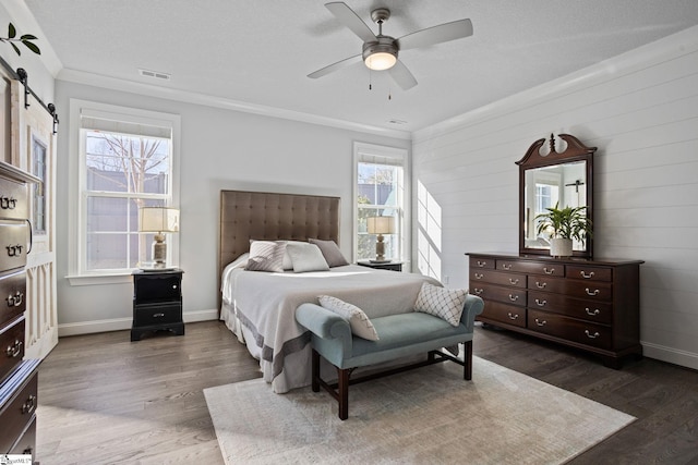 bedroom with ceiling fan, ornamental molding, dark wood-type flooring, and multiple windows