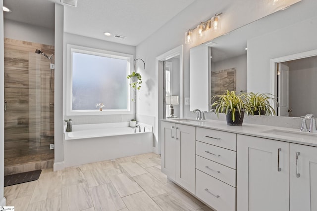 bathroom featuring vanity and separate shower and tub