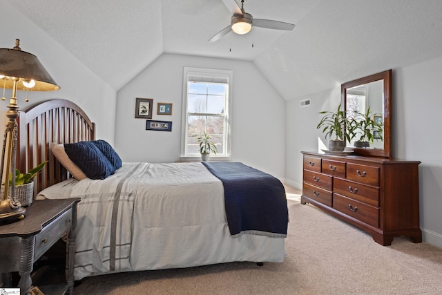 carpeted bedroom featuring ceiling fan, a textured ceiling, and vaulted ceiling