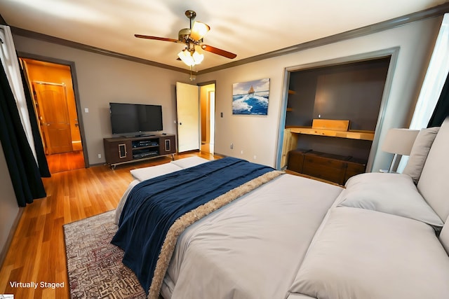 bedroom featuring wood-type flooring, ceiling fan, and crown molding