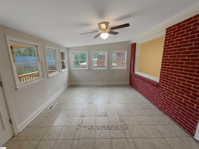 unfurnished sunroom with ceiling fan and vaulted ceiling