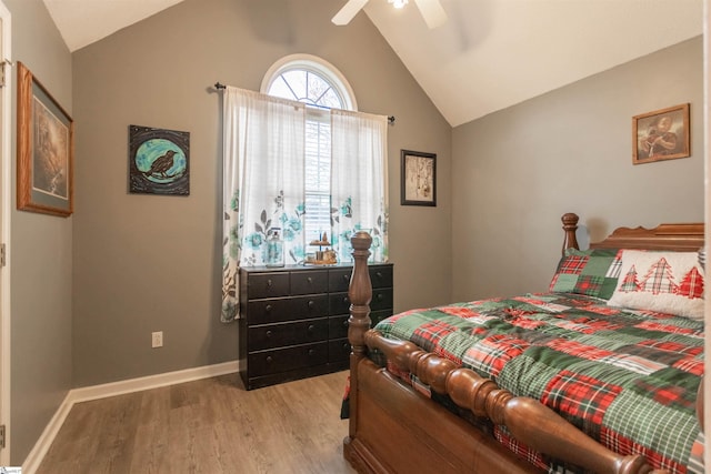 bedroom with vaulted ceiling, light hardwood / wood-style flooring, and ceiling fan