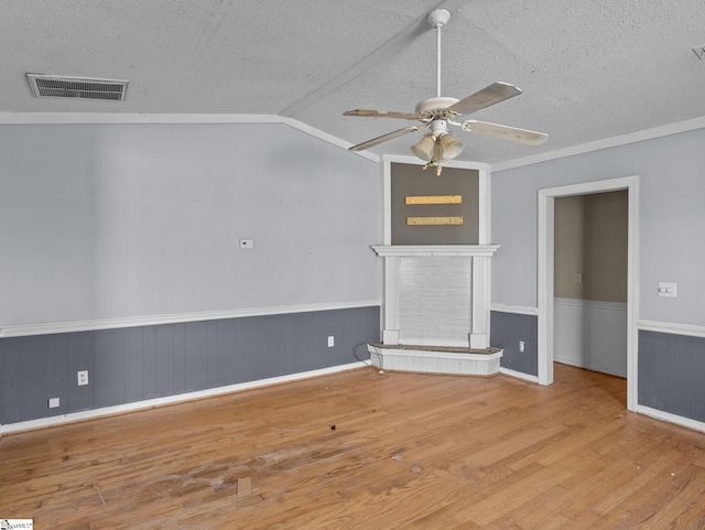 unfurnished living room featuring ceiling fan, light wood-type flooring, a textured ceiling, and vaulted ceiling