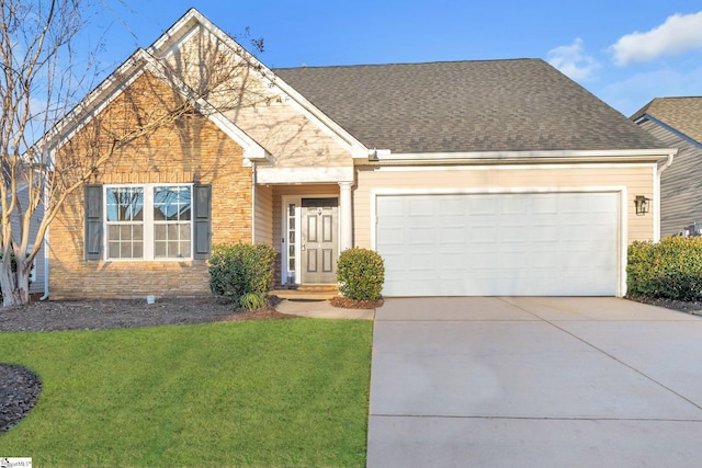 view of front of house featuring a garage and a front lawn