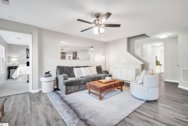 living room featuring hardwood / wood-style flooring and ceiling fan