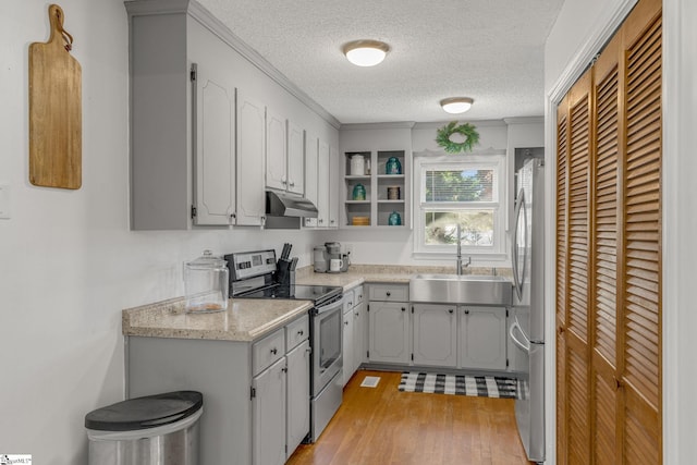 kitchen with a textured ceiling, stainless steel appliances, gray cabinetry, and sink