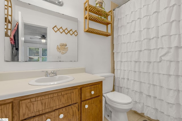 bathroom with a shower with curtain, vanity, ceiling fan, tile patterned flooring, and toilet