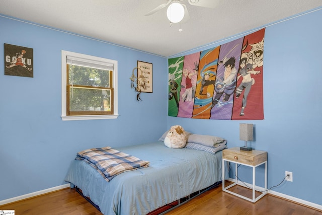 bedroom with hardwood / wood-style floors and ceiling fan