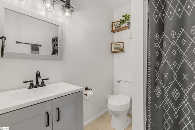 bathroom with tile patterned flooring, vanity, and toilet