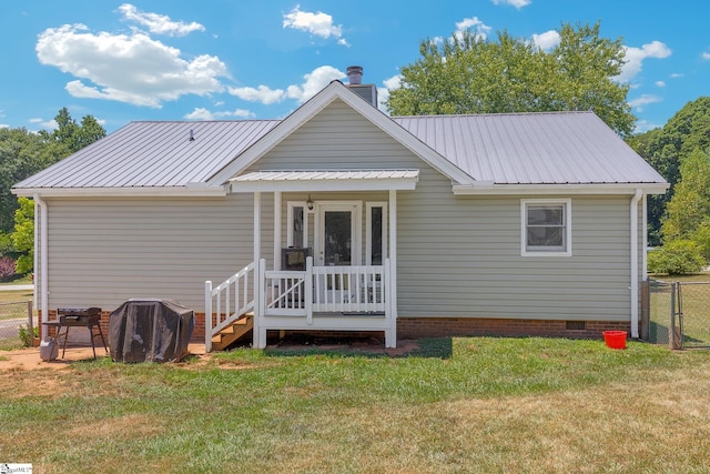 back of property with a yard