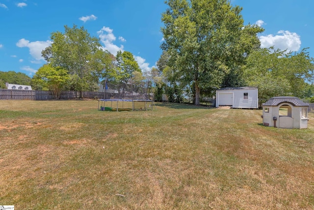 view of yard featuring a shed and a trampoline