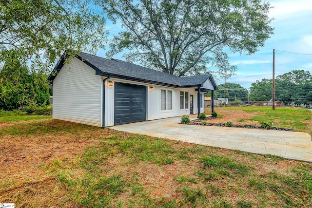 exterior space with a garage and a front lawn