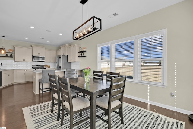 dining area featuring dark hardwood / wood-style flooring and sink