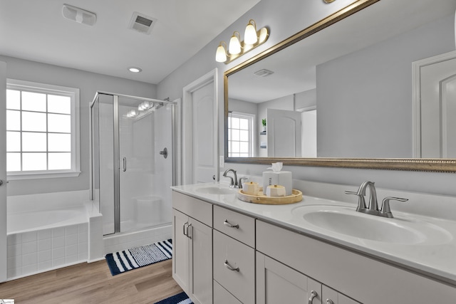 bathroom with hardwood / wood-style flooring, vanity, and independent shower and bath