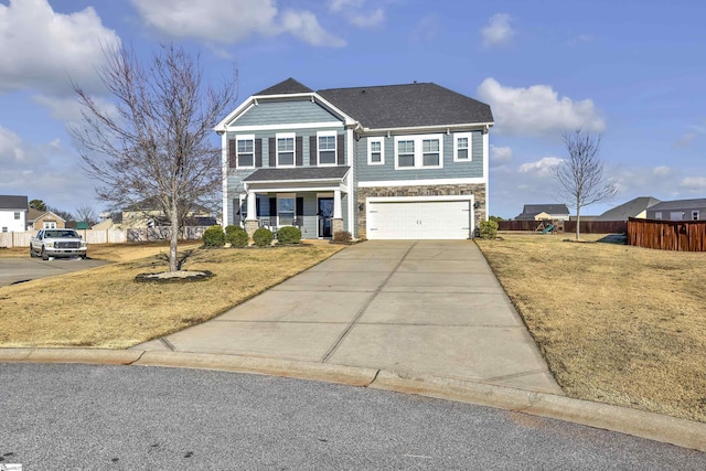 view of front of home featuring covered porch, a front yard, and a garage