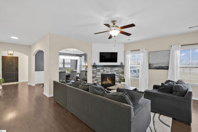 living room with a fireplace, dark hardwood / wood-style flooring, and ceiling fan