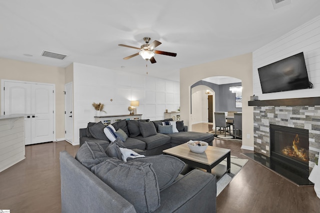 living room with ceiling fan and dark wood-type flooring