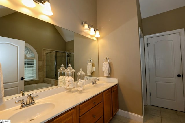 bathroom featuring tile patterned flooring, vanity, independent shower and bath, and vaulted ceiling