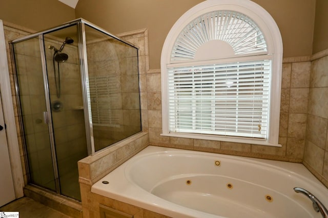 bathroom featuring independent shower and bath