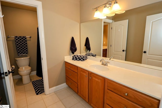 bathroom featuring tile patterned floors, vanity, and toilet