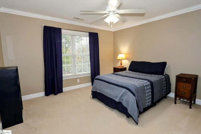 carpeted bedroom with ceiling fan and crown molding