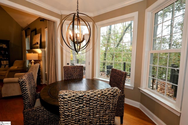 dining room featuring a chandelier, hardwood / wood-style flooring, and ornamental molding